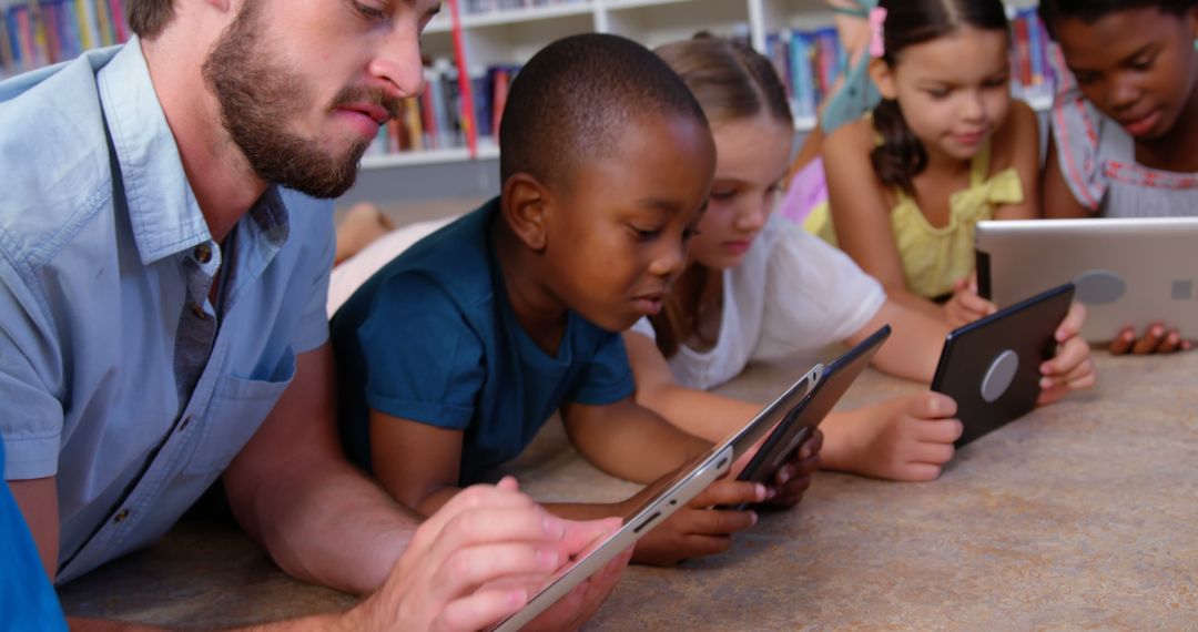 Teacher and Diverse Children Using Tablets in Classroom - Free Images, Stock Photos and Pictures on Pikwizard.com