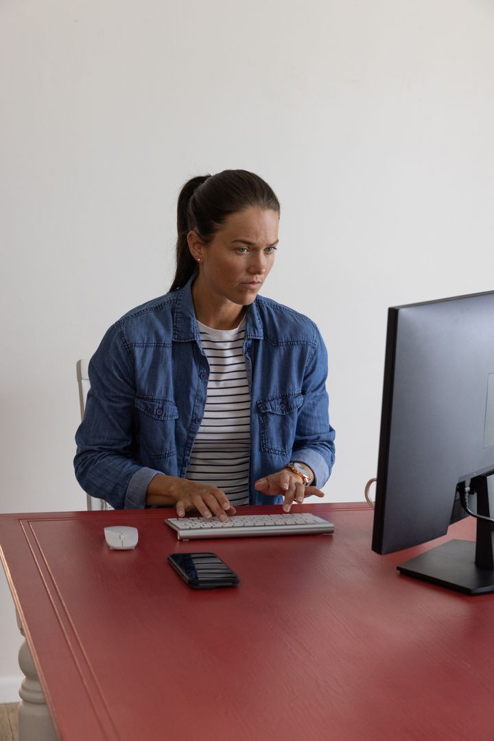 Focused Woman in Modern Home Office Type on Keyboard