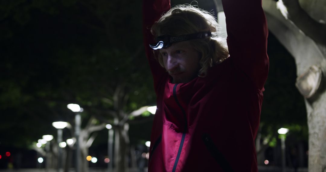 Male Runner Wearing Headlamp Stretching During Night Run - Free Images, Stock Photos and Pictures on Pikwizard.com