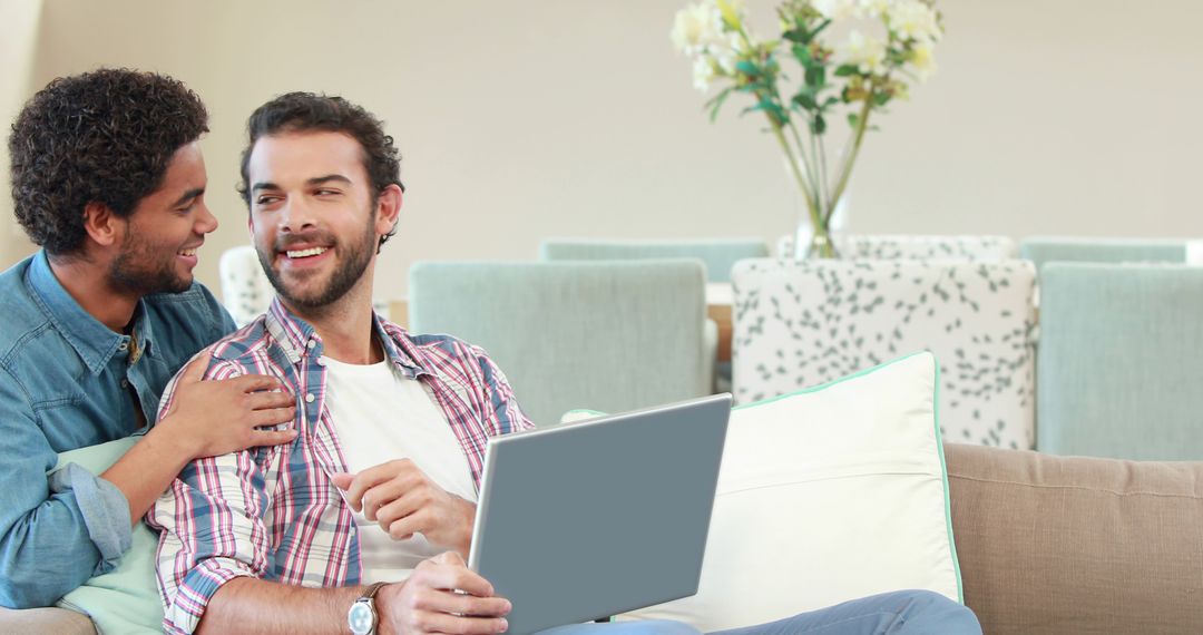 Joyful Couple Bonding at Home with Laptop