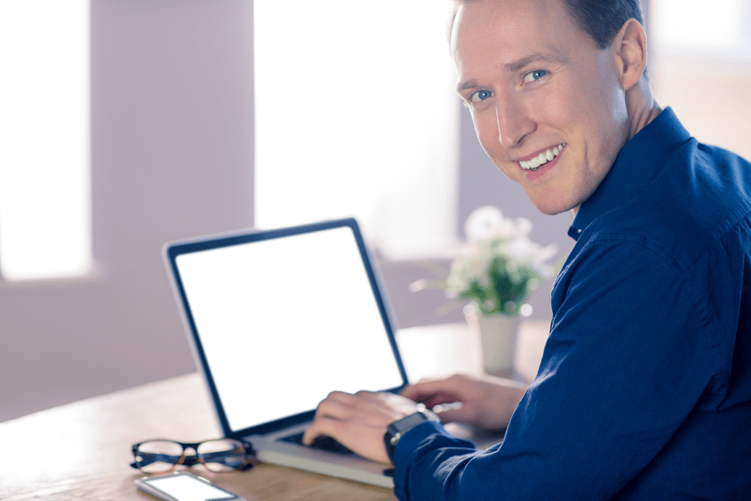 Smiling Businessman with Transparent Laptop Screen in Office