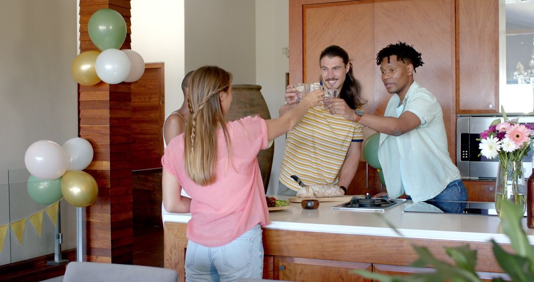 Friends Toasting in Kitchen While Celebrating Party Gathering