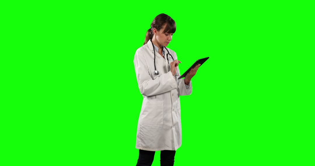 Female doctor using digital tablet on green screen background - Free Images, Stock Photos and Pictures on Pikwizard.com