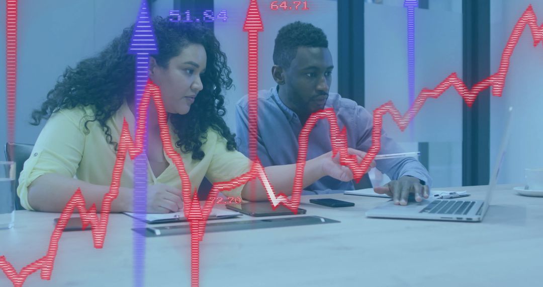 Business Colleagues Reviewing Stock Market Data with Overlaid Charts