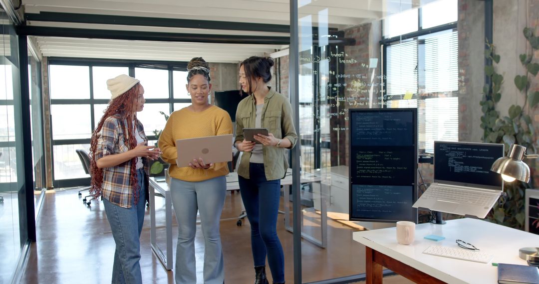 Diverse Team Collaborating on Coding Project in Modern Office