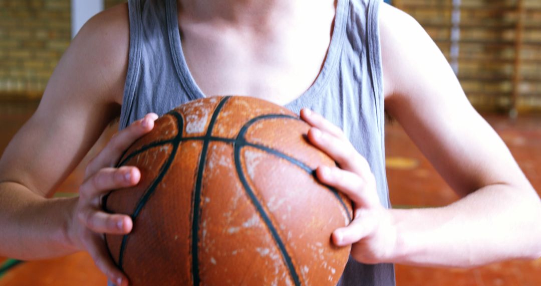 Young Player Holding Basketball Ready to Shoot Indoors - Free Images, Stock Photos and Pictures on Pikwizard.com