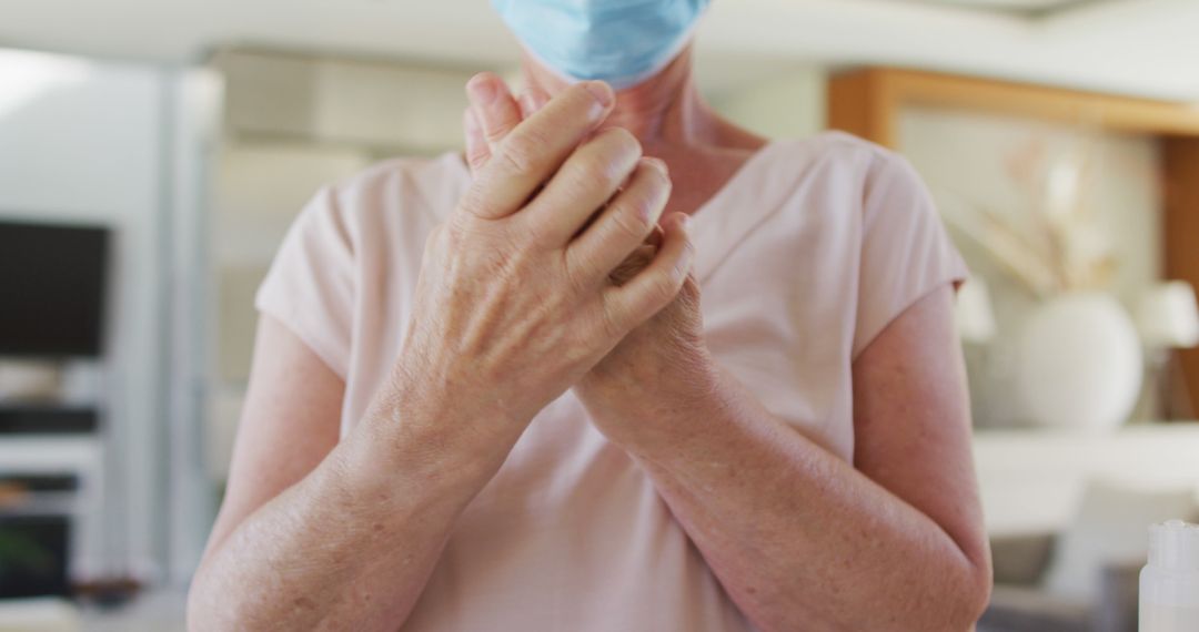 Healthcare Worker Wearing Mask Sanitizing Hands Indoors - Free Images, Stock Photos and Pictures on Pikwizard.com