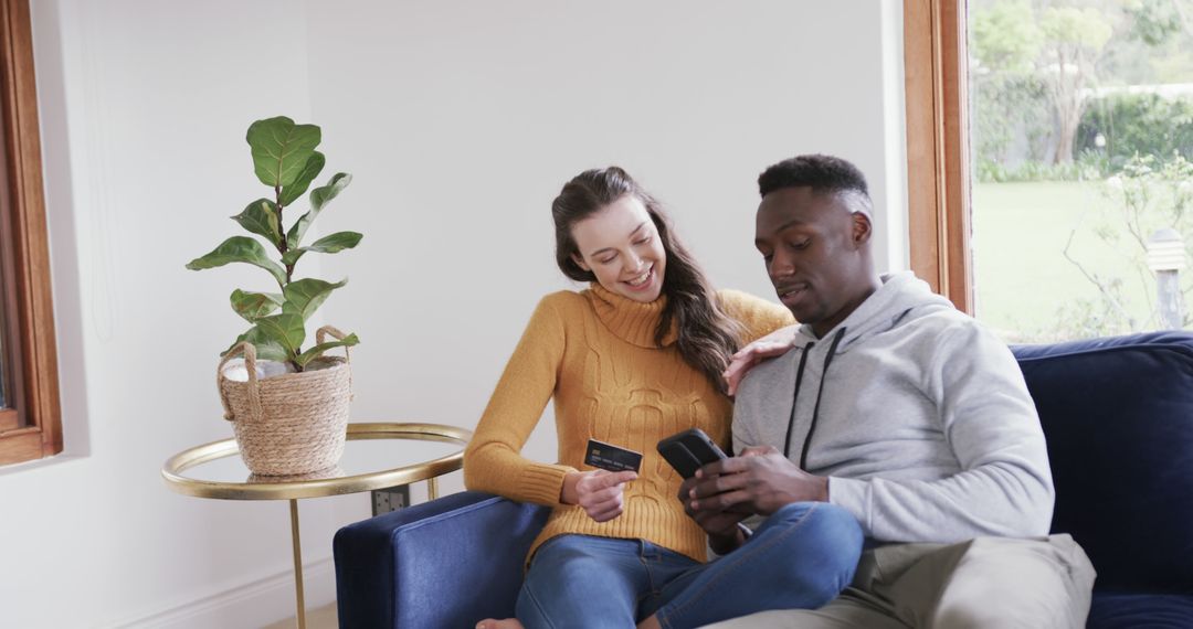 Diverse Couple Shopping Online Using Smartphone and Credit Card Home
