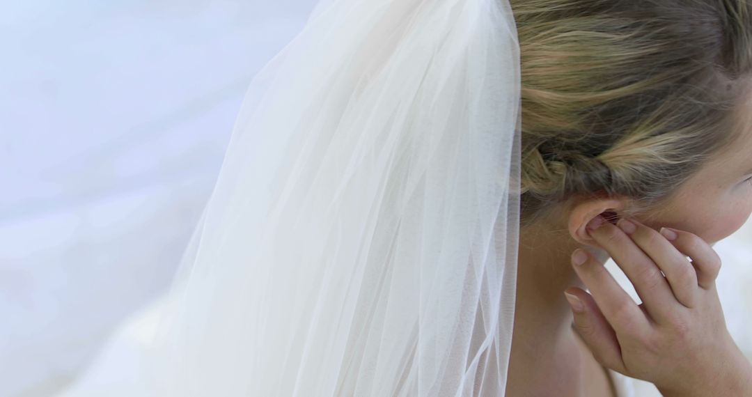 Bride Contemplating Gently with Delicate Wedding Veil - Free Images, Stock Photos and Pictures on Pikwizard.com