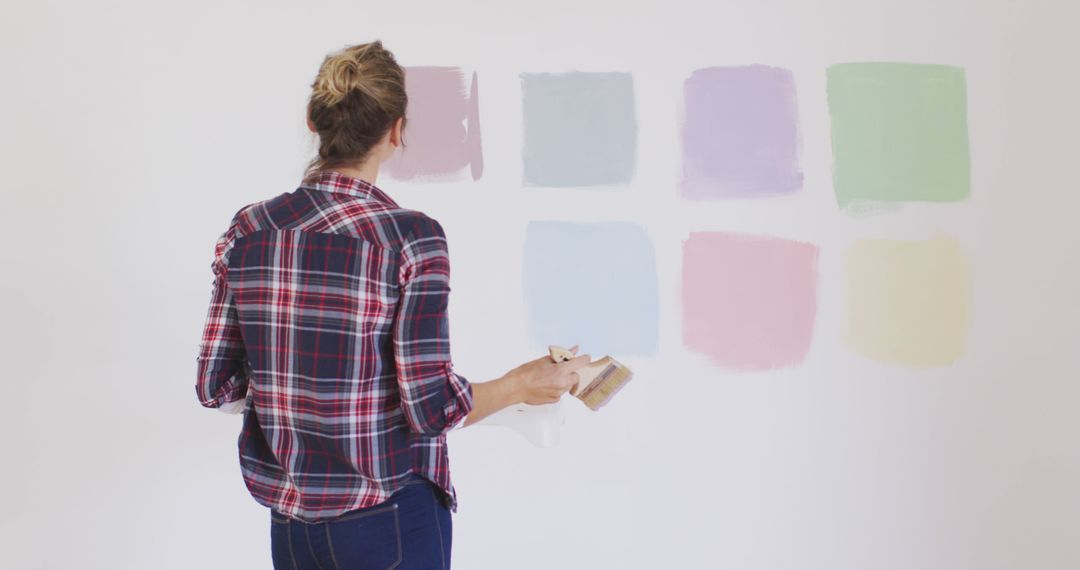 Woman Choosing Paint Colors from Palette on Wall - Free Images, Stock Photos and Pictures on Pikwizard.com