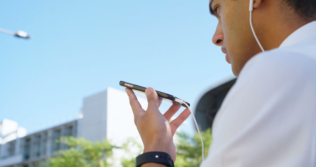 Businessman Recording Voice Memo on Smartphone Outdoors - Free Images, Stock Photos and Pictures on Pikwizard.com