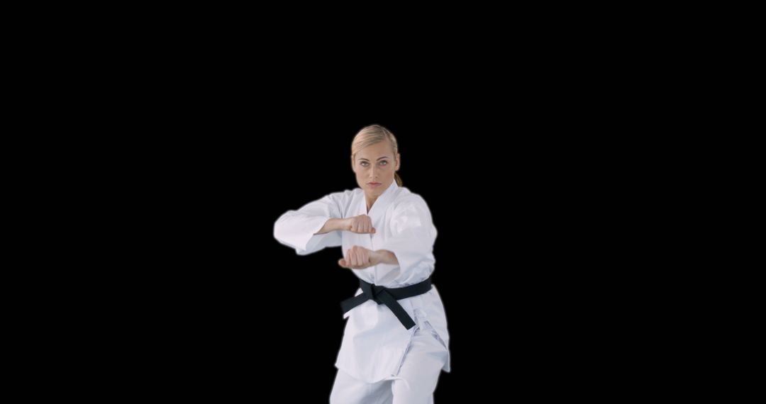 Female Martial Artist Practicing Karate in White Gi and Black Belt - Free Images, Stock Photos and Pictures on Pikwizard.com