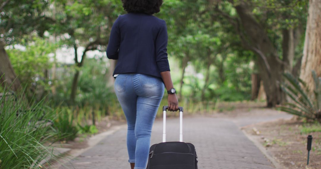 Woman Pulling Suitcase Along Wooded Path During Vacation - Free Images, Stock Photos and Pictures on Pikwizard.com