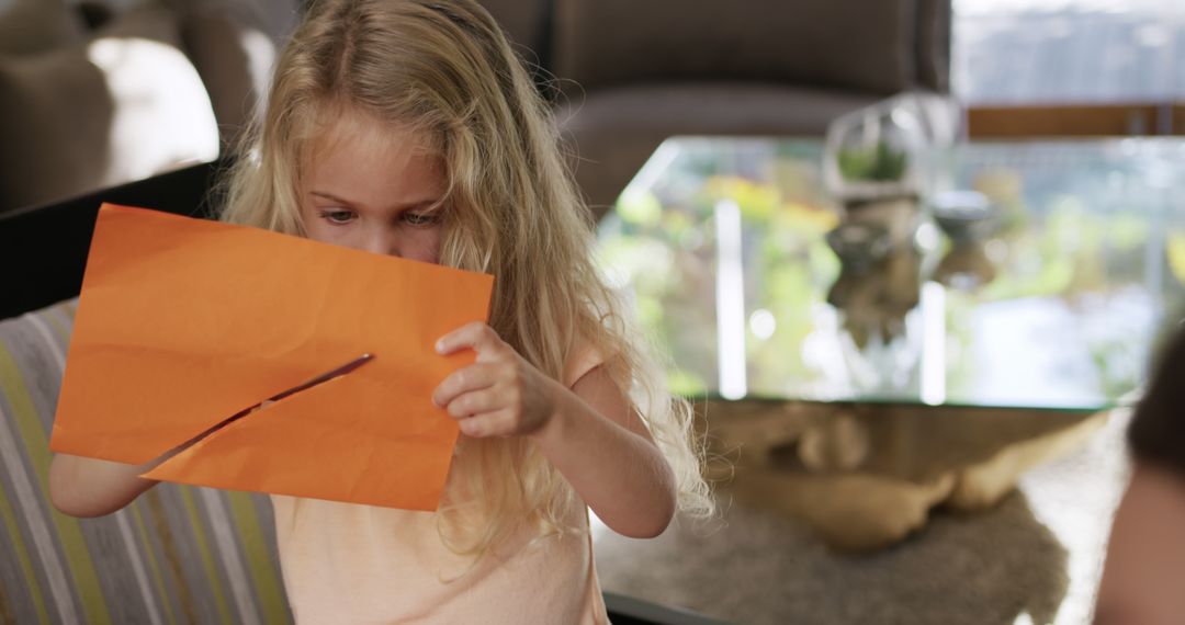 Curious Girl Opening Envelope with Attention - Free Images, Stock Photos and Pictures on Pikwizard.com