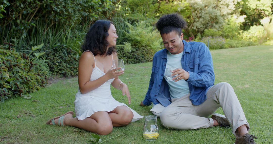 Friends Enjoying Refreshing Drinks in Sunny Garden