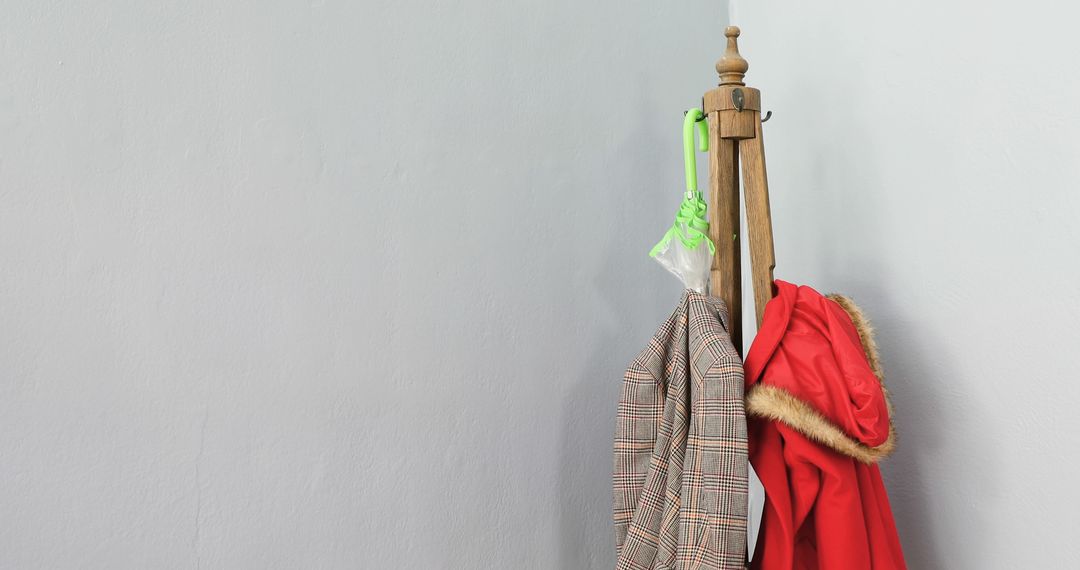 Vintage Coat Rack with Red Jacket and Plaid Blazer in Minimalist Room - Free Images, Stock Photos and Pictures on Pikwizard.com