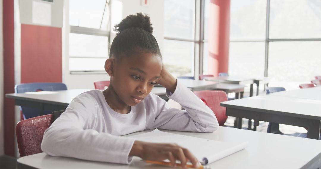 Young Student Concentrating on Schoolwork in Modern Classroom