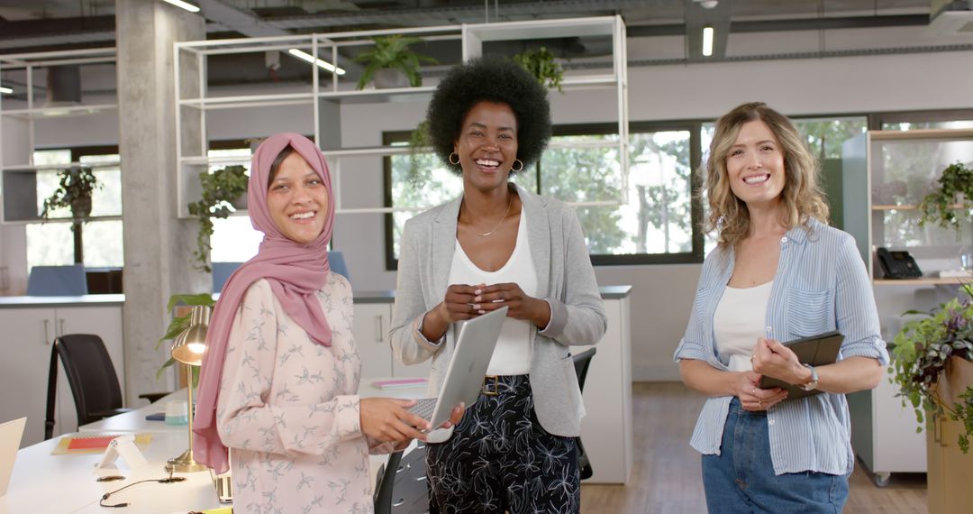 Diverse Female Team Collaborating Happily in Modern Office