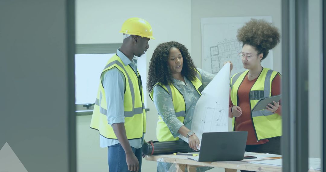 Diverse Engineering Team Analyzing Blueprints at Construction Site