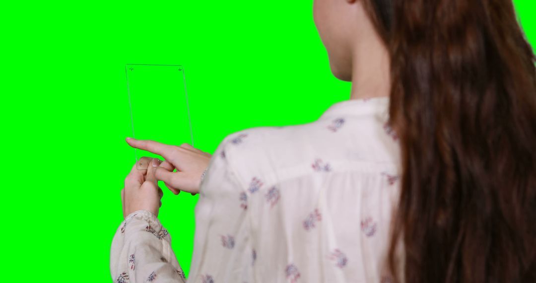 Woman Interacting with Transparent Device Against Green Screen - Free Images, Stock Photos and Pictures on Pikwizard.com