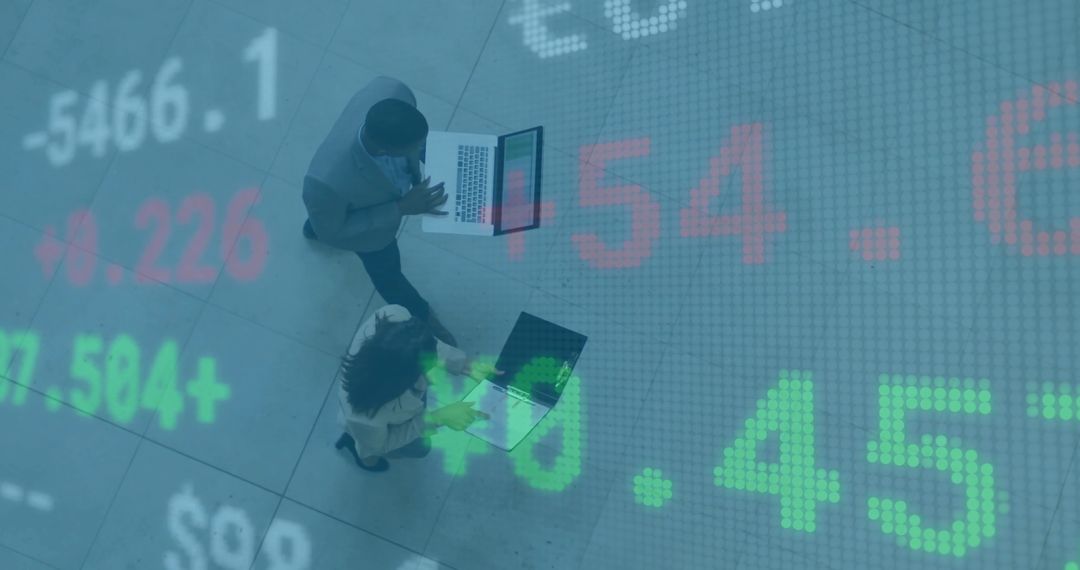Business Professionals Analyzing Market Data with Stock Numbers Overlay