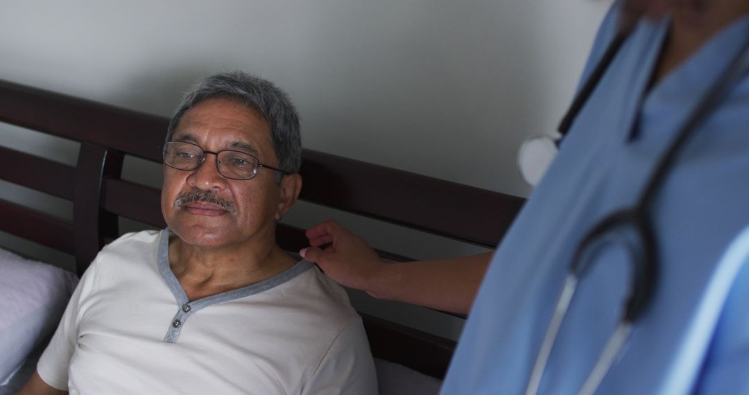 Elderly Man Sitting on Bed with Caregiver Offering Comfort - Free Images, Stock Photos and Pictures on Pikwizard.com