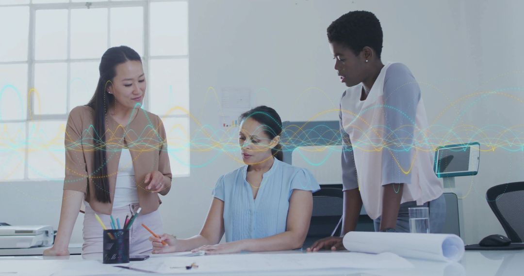 Collaborating Female Team Reviewing Architectural Plans Around Bright Modern Office Table