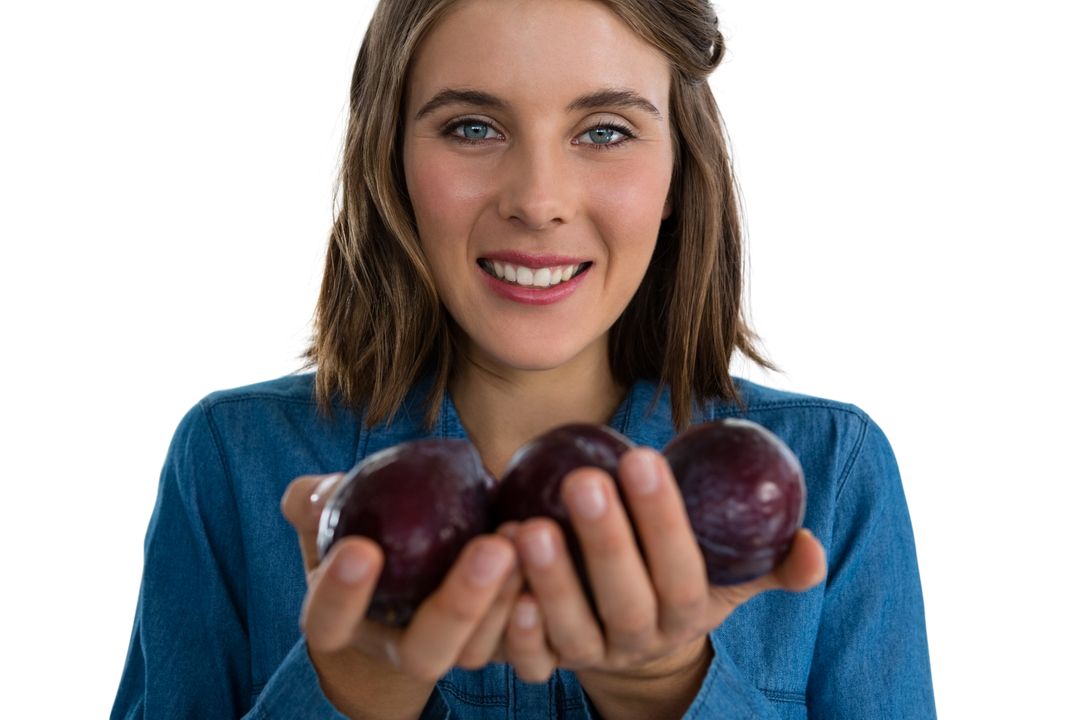 Portrait of young woman holding plums - Free Images, Stock Photos and Pictures on Pikwizard.com