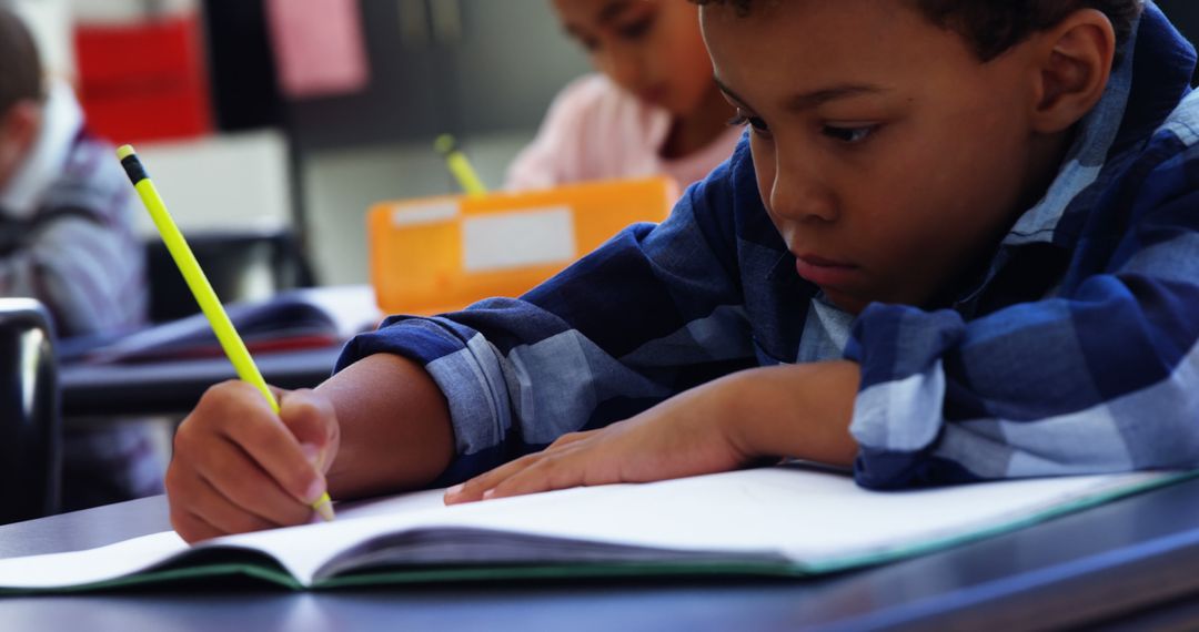 Focused African American Boy Writing in Classroom - Free Images, Stock Photos and Pictures on Pikwizard.com