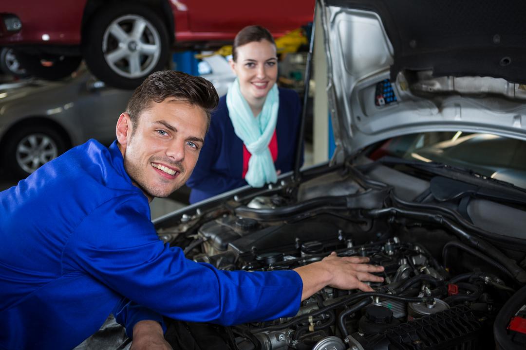 Mechanic explaining car issues to customer in repair garage - Free Images, Stock Photos and Pictures on Pikwizard.com