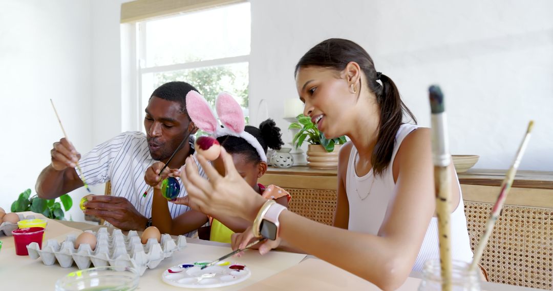 Family Decorating Easter Eggs Together at Home