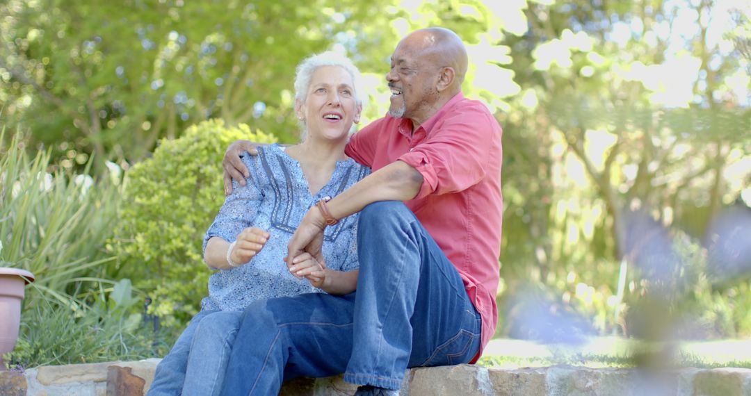 Senior Biracial Couple Enjoying Leisure Time in Garden