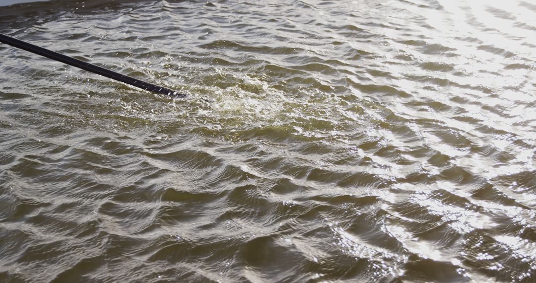 Rippling Water Surface with Oar in Motion - Free Images, Stock Photos and Pictures on Pikwizard.com