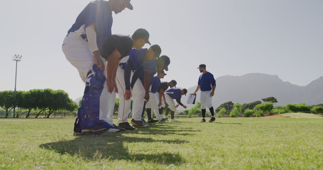 Baseball Team Preparing for Practice Drills on Sunny Field - Free Images, Stock Photos and Pictures on Pikwizard.com