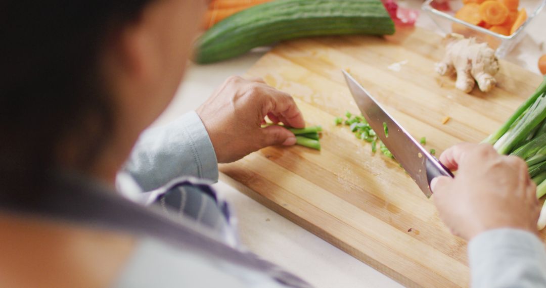 Senior Woman Chopping Vegetables in Cozy Kitchen Scene - Free Images, Stock Photos and Pictures on Pikwizard.com