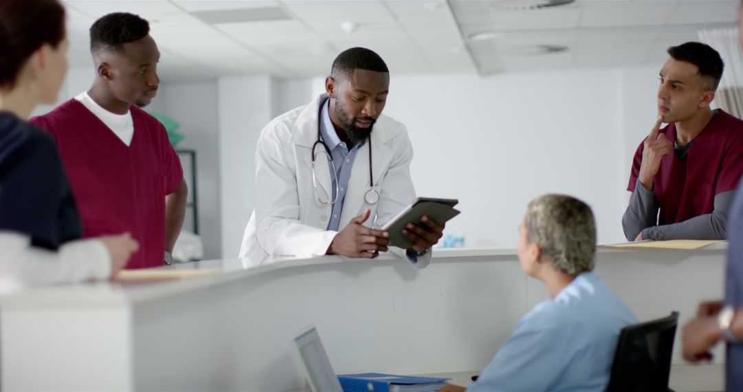 Doctors Collaborating with Tablet Near Reception in Hospital