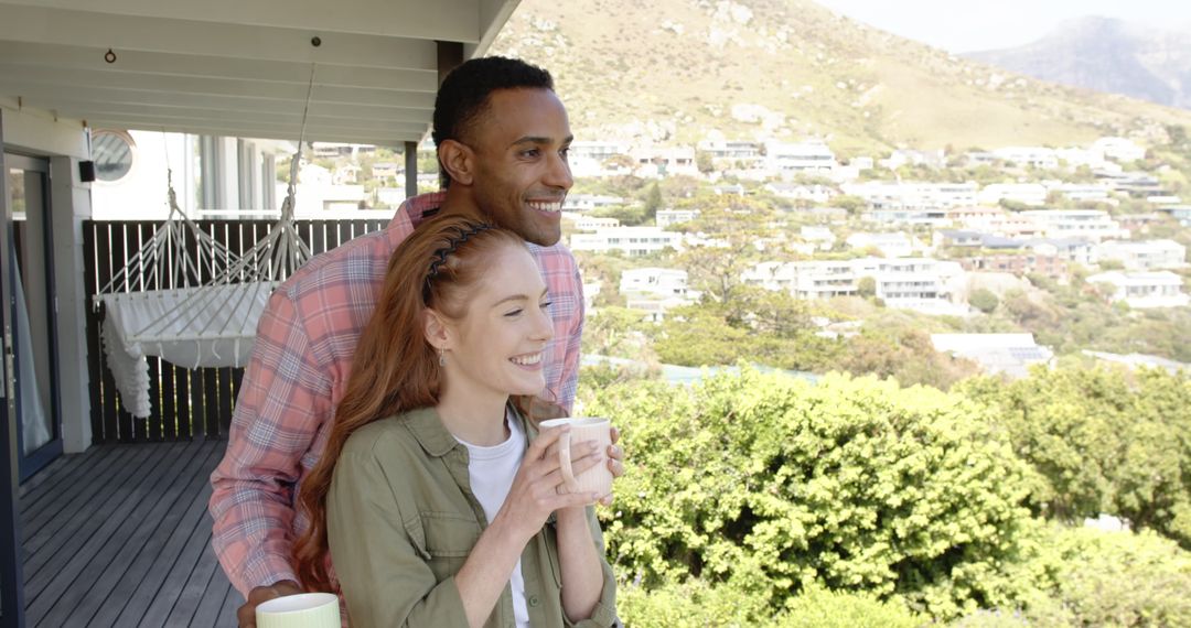Happy Couple Enjoying Scenic Hillside View on Balcony