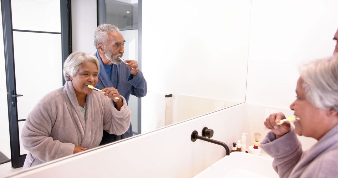 Senior Couple Brushing Teeth Together in Bathroom Mirror Reflection - Free Images, Stock Photos and Pictures on Pikwizard.com