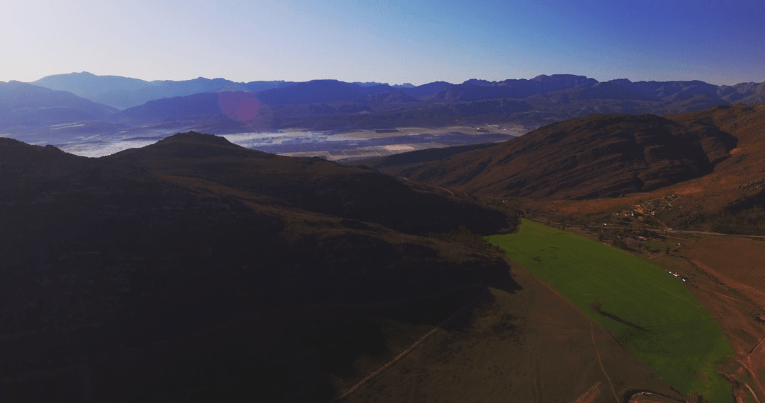 Transparent Valley Landscape with Verdant Fields and Mountains
