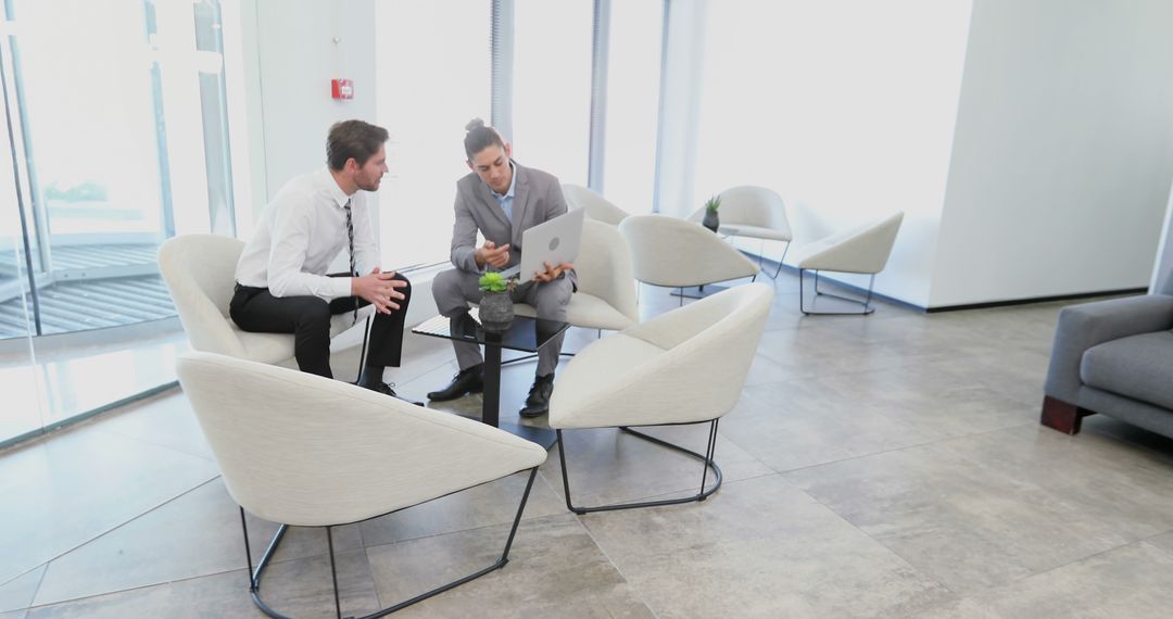 Business Colleagues Discussing Project in Modern Office Lobby - Free Images, Stock Photos and Pictures on Pikwizard.com