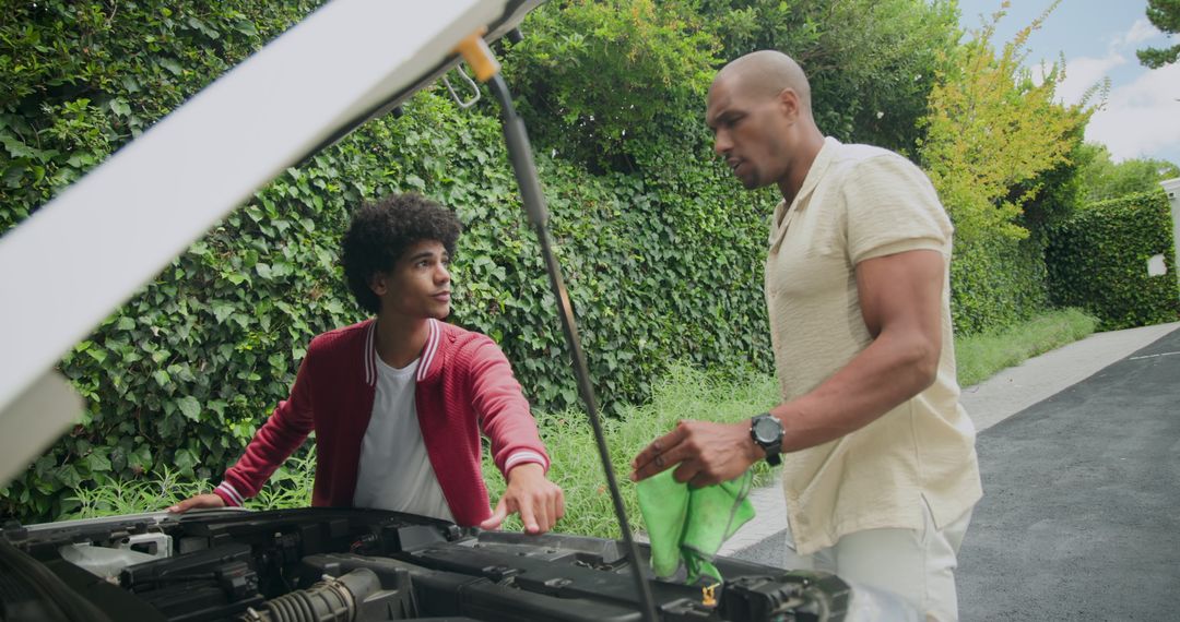 Father and Son Teamwork Checking Car Engine in Garden Driveway