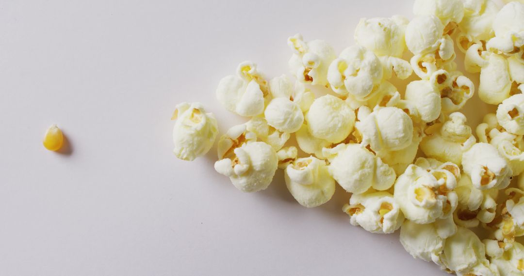 Minimalist Popcorn and Kernel on White Background