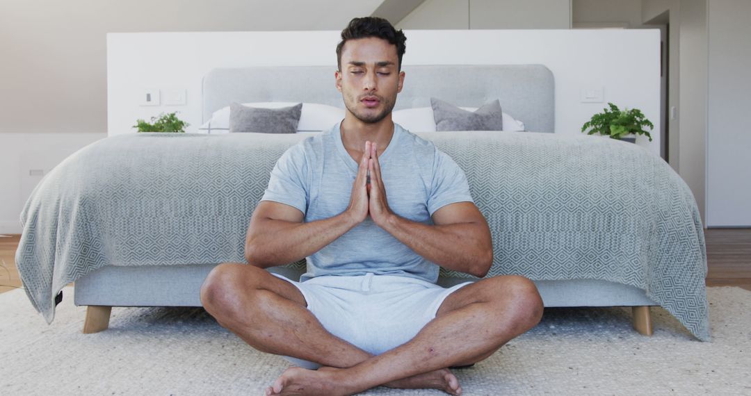 Man Practicing Meditation in Bedroom for Relaxation and Mindfulness - Free Images, Stock Photos and Pictures on Pikwizard.com