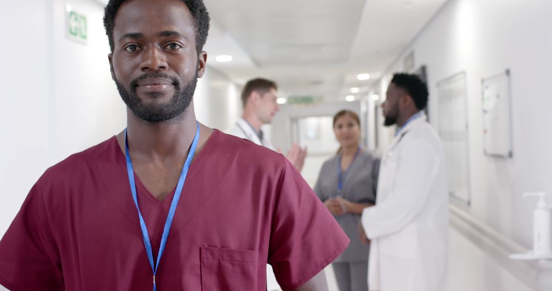 Confident Male Nurse Smiling in Hospital Hallway - Free Images, Stock Photos and Pictures on Pikwizard.com