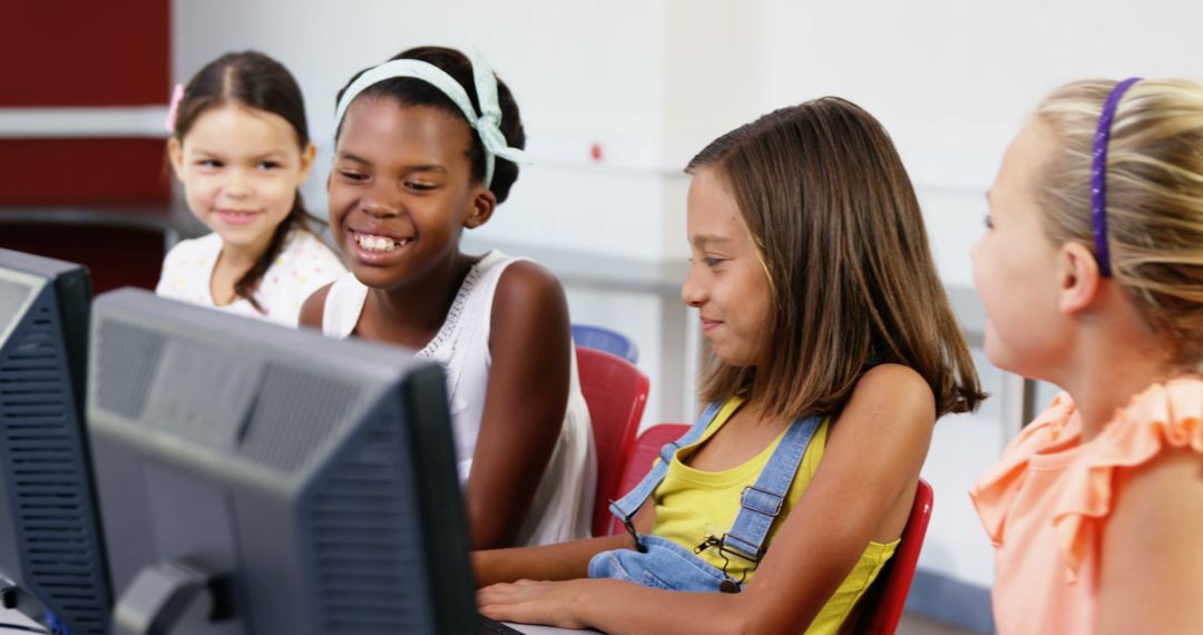 Girls Engaged in Collaborative Learning on Computers in Classroom