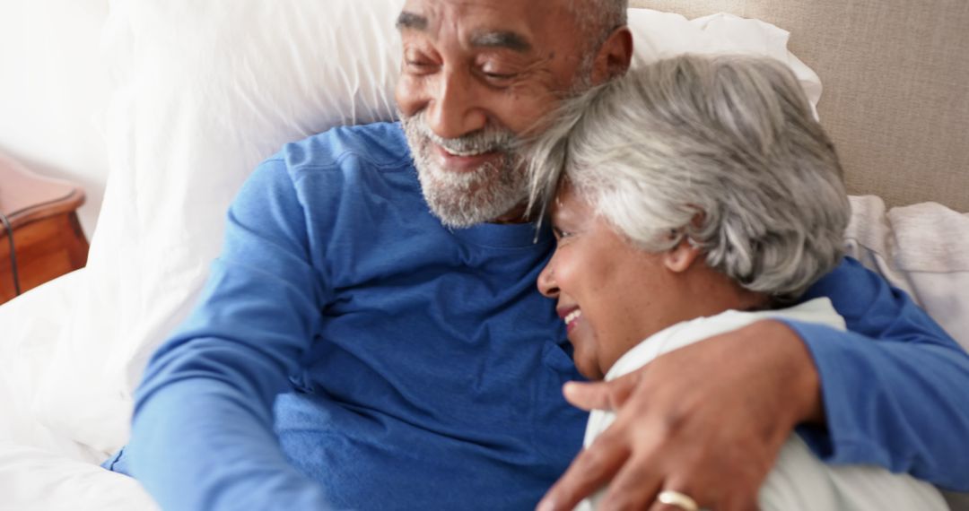 Senior Couple Embracing and Smiling in Bed - Free Images, Stock Photos and Pictures on Pikwizard.com