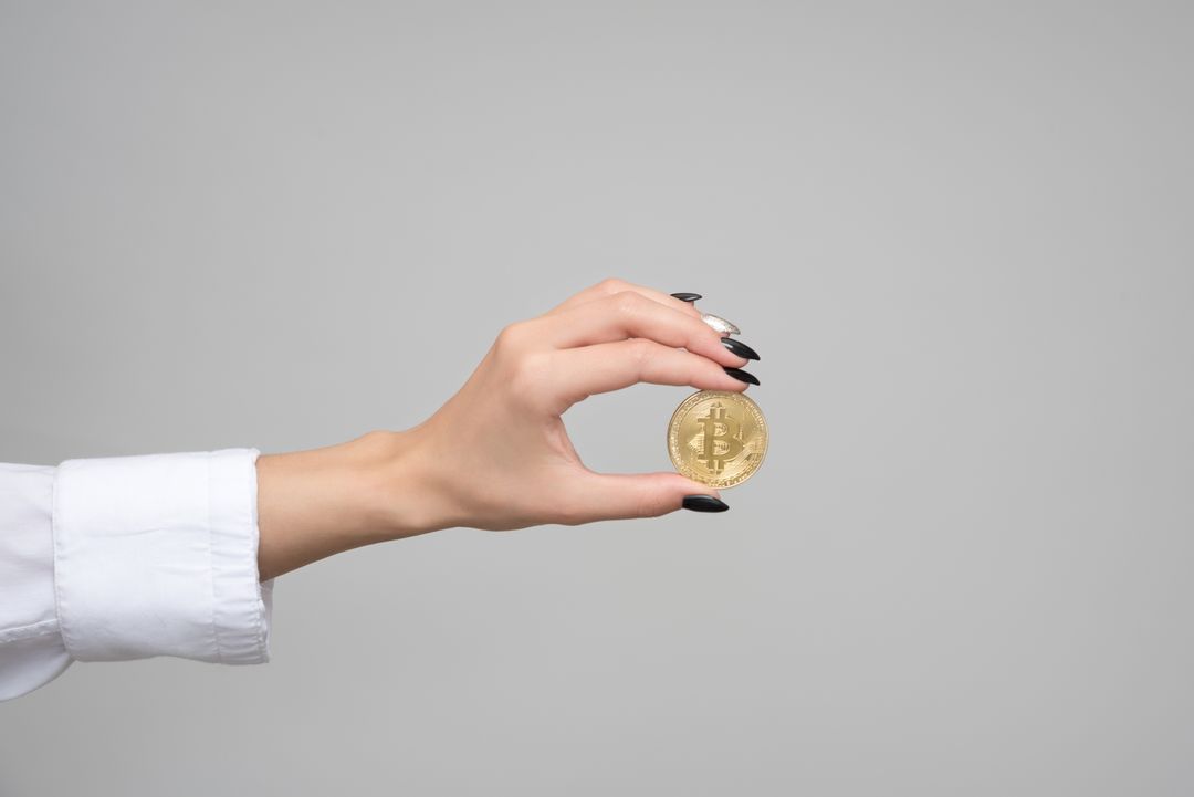 Hand Holding Bitcoin Symbolizing Cryptocurrency and Finance