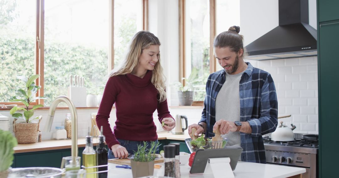 Couple Preparing Dinner Together Using Tablet at Modern Kitchen