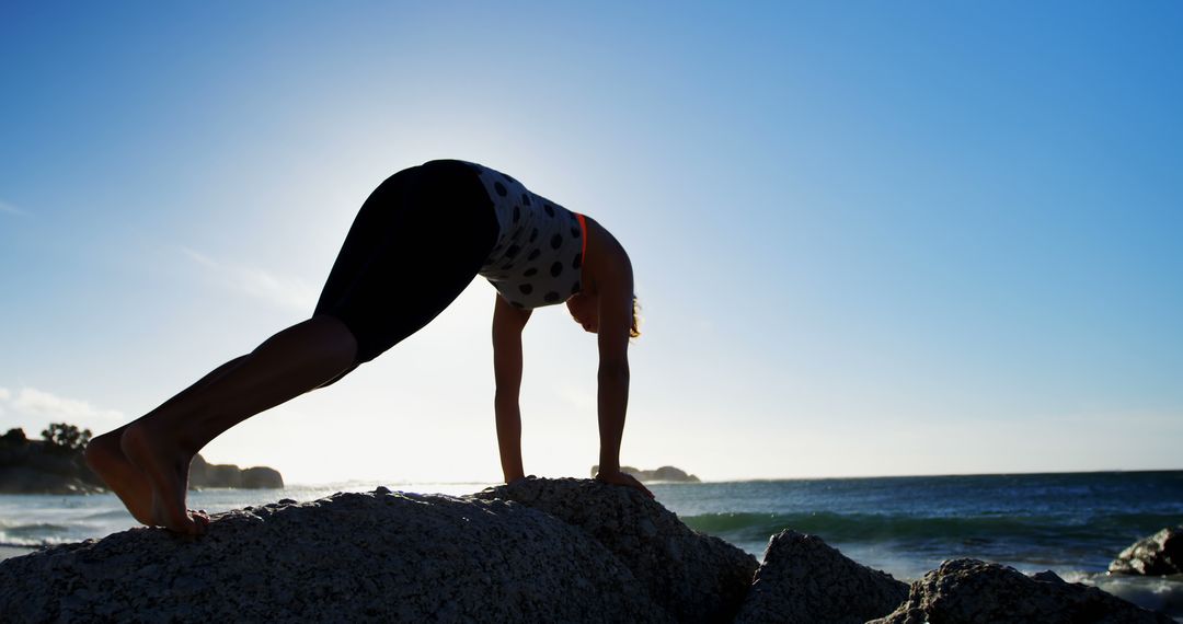 Woman Practicing Yoga on Rocky Beach at Sunset - Free Images, Stock Photos and Pictures on Pikwizard.com