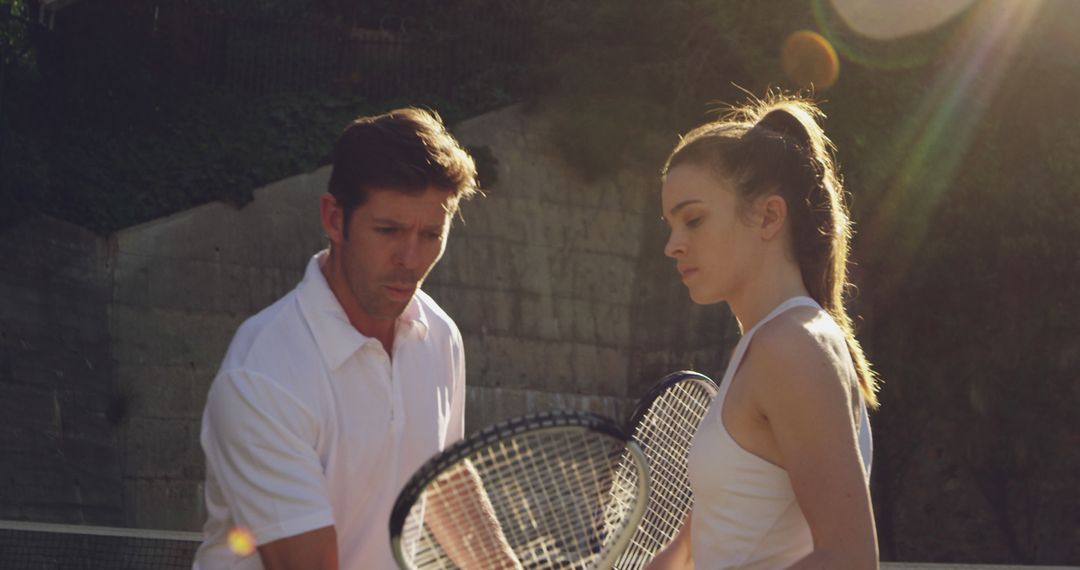 Professional Tennis Coach Instructing Young Female Player During Training Session - Free Images, Stock Photos and Pictures on Pikwizard.com